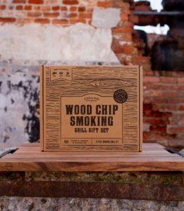 Lifestyle and Product Photography Example for Amazon - Cooking Gift Set Co.'s Wood Chip Smoking Kit sitting on a hardwood cutting board, backed by a rustic brick wall - Design & Photography by Fuze Branding