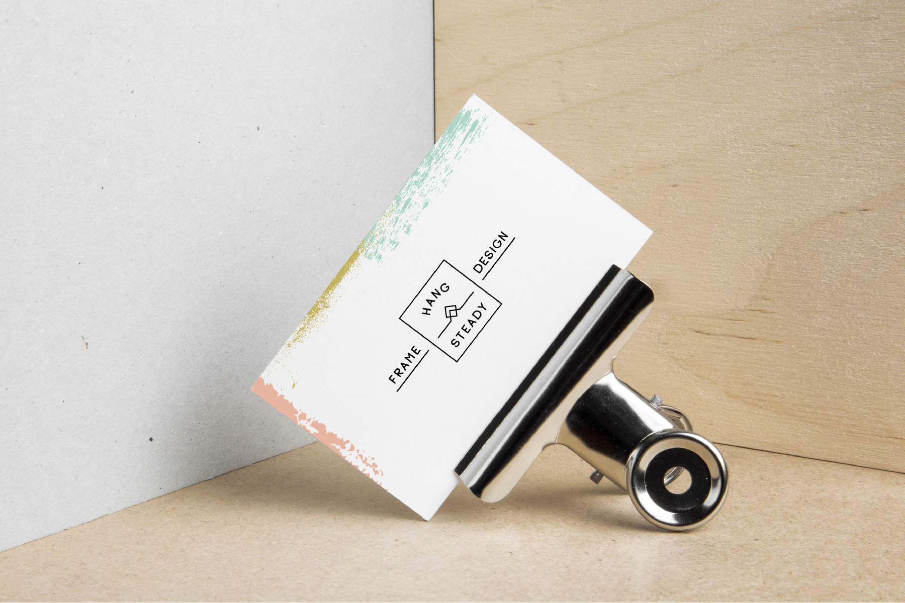 Business card on binder clip with paint splatter details