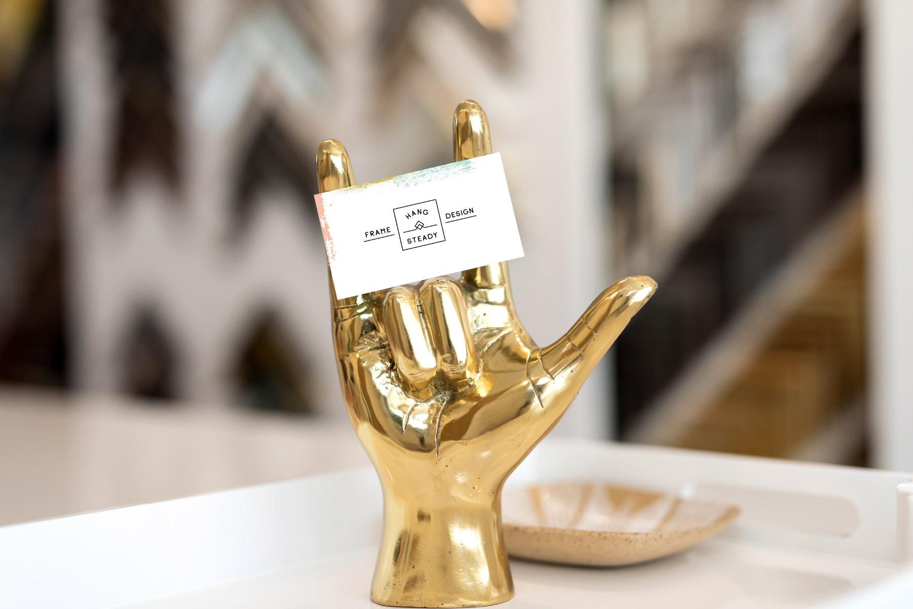 Business card on sign of the horns hand gesture statue