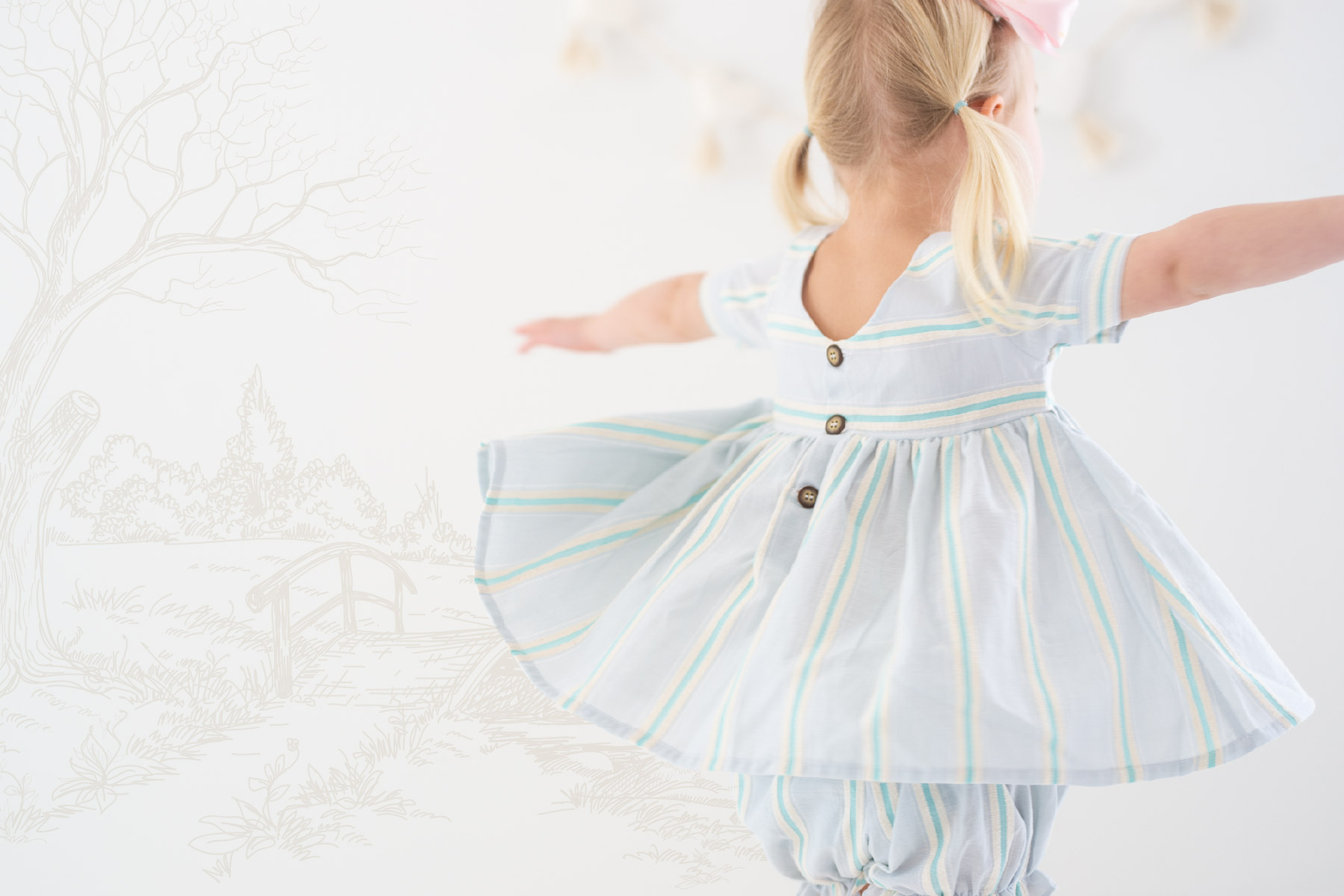Young girl dancing in handmade light colored dress with tree illustrations in the background