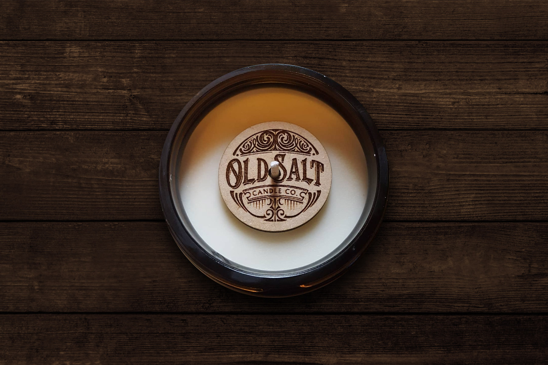 wooden coin with old salt logo on top of candle