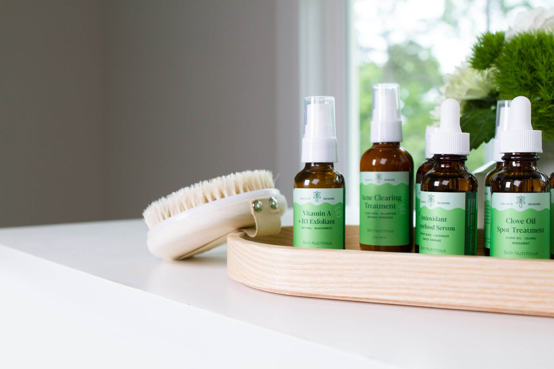 Holistic skincare product line sitting on wooden tray